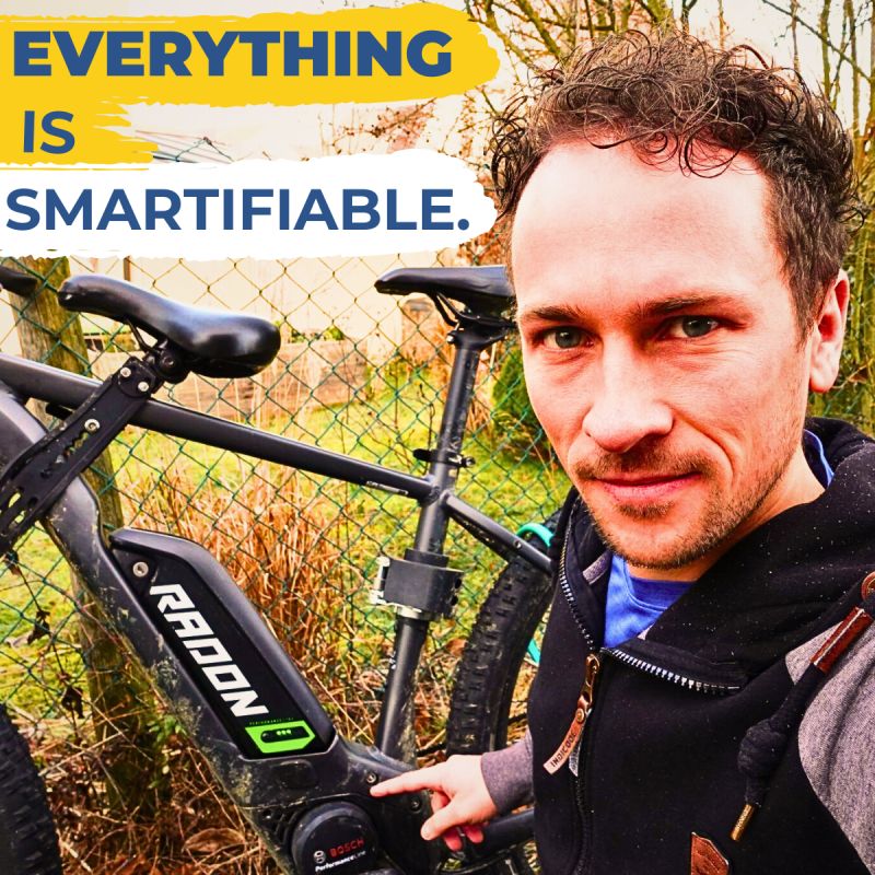 Lukas standing next to a Radon electric mountain bike with a motivational quote in the background.